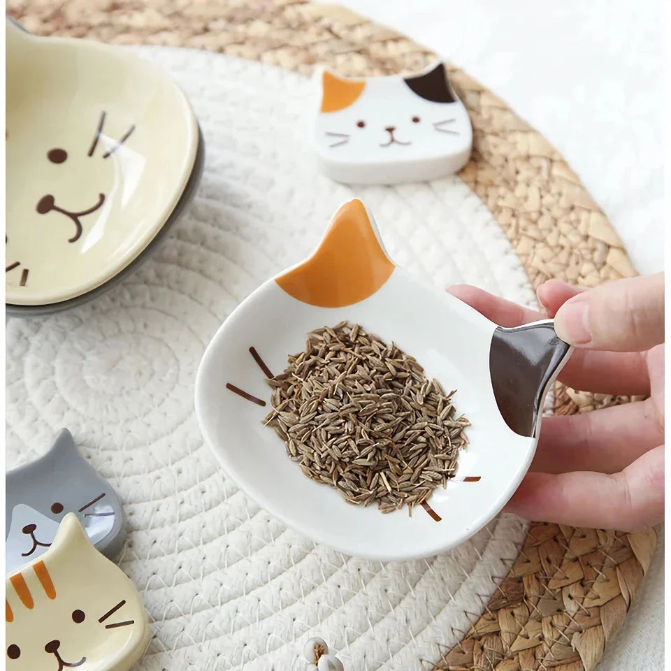 A charming Japanese-style ceramic dish featuring a cute cat design, perfect for serving sauces, dips, and small portions in style.