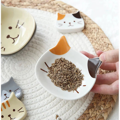 A charming Japanese-style ceramic dish featuring a cute cat design, perfect for serving sauces, dips, and small portions in style.