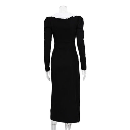 Black and white color-blocked dress with long sleeves and a doll collar, showcasing a timeless and sophisticated style.