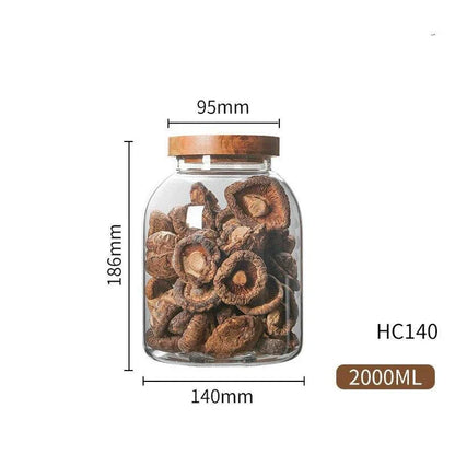 Airtight glass food storage jars with wooden lids in various sizes, perfect for organizing and preserving dry goods, spices, and pantry items in the kitchen.