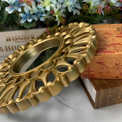 Elegant gold floral wall mirror with round design and metal frame, perfect for home decor