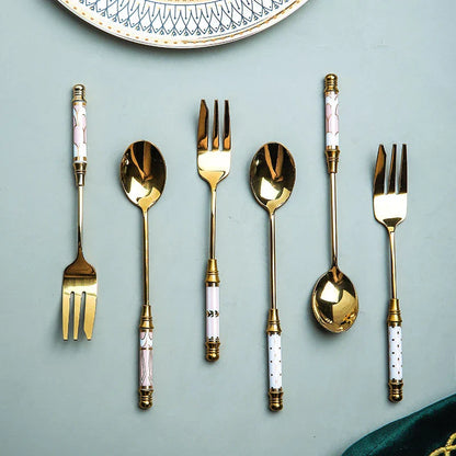 Elegant gold-plated dessert fork with intricate ceramic handle design