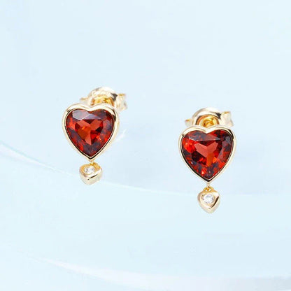 Elegant heart-shaped earrings with natural garnet and zircon stones in a pomegranate color, showcasing a timeless, versatile design.