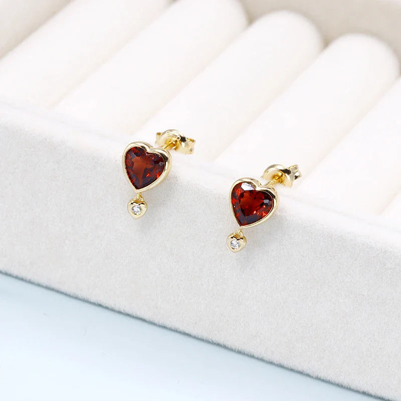 Elegant heart-shaped earrings with natural garnet and zircon stones in a pomegranate color, showcasing a timeless, versatile design.