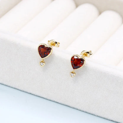 Elegant heart-shaped earrings with natural garnet and zircon stones in a pomegranate color, showcasing a timeless, versatile design.