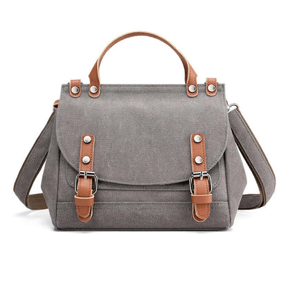 A stylish women's canvas crossbody handbag in an orange color, featuring a small square shape and a horizontal design.