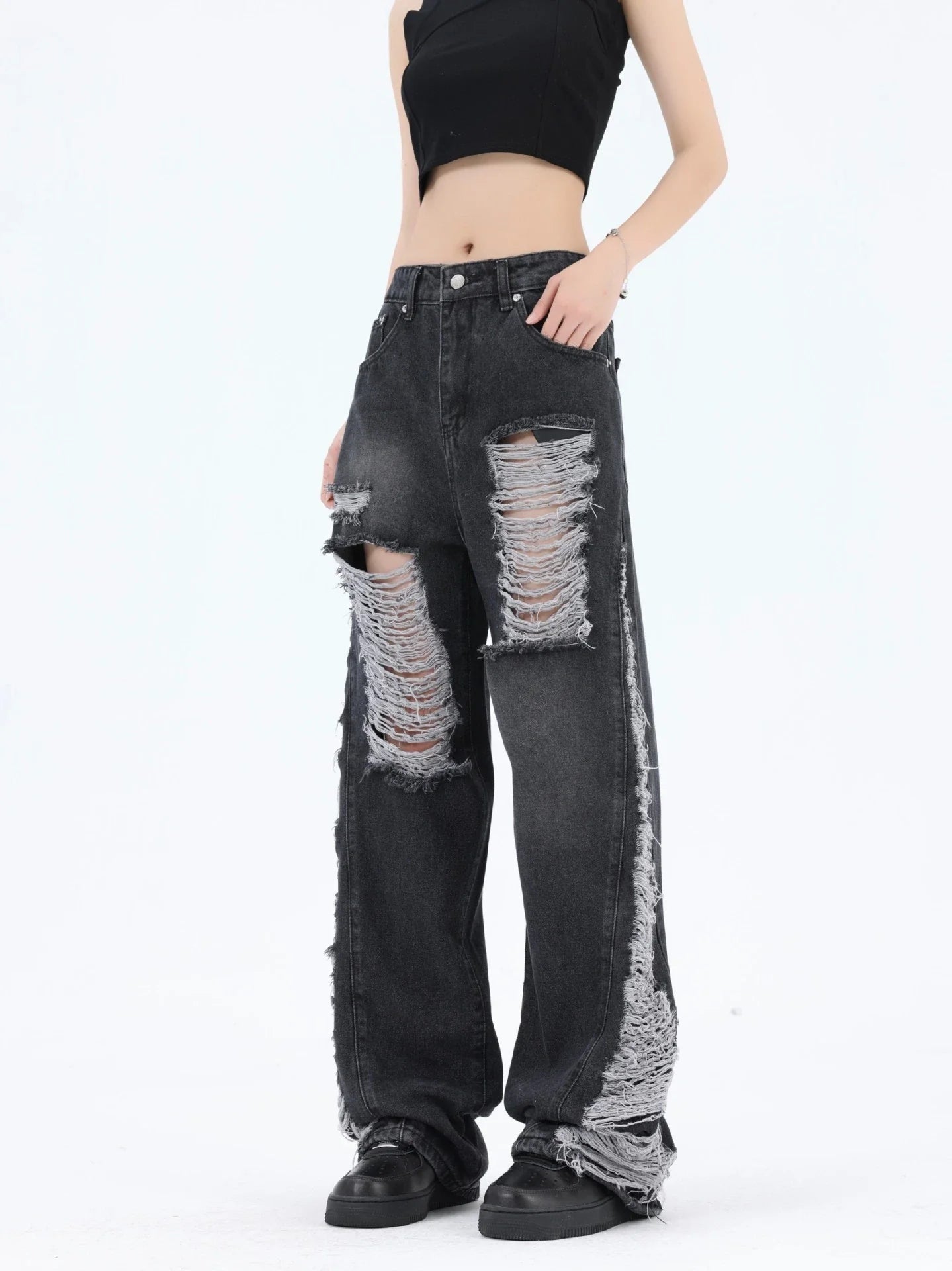 Premium loose fit distressed denim trousers for men and women, featuring a relaxed silhouette, high-quality cotton construction, and trendy distressed details.