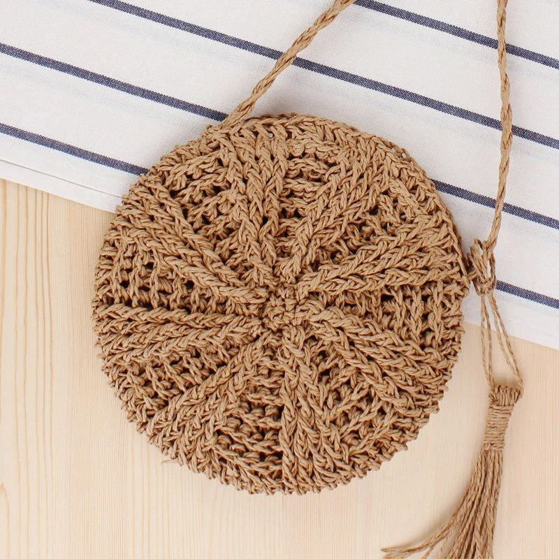 Bohemian rattan round crossbody bag in beige color with tassel accent, perfect for summer outings and beach parties