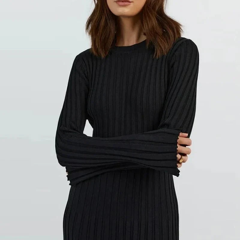 Timeless elegant pleated knit dress in black, perfect for summer office wear with a sophisticated and comfortable design.