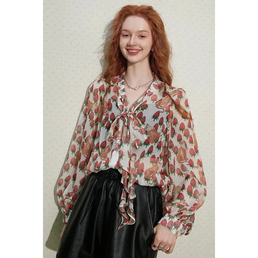 Elegant floral chiffon blouse with lantern sleeves, featuring a vibrant floral pattern and a delicate bow collar