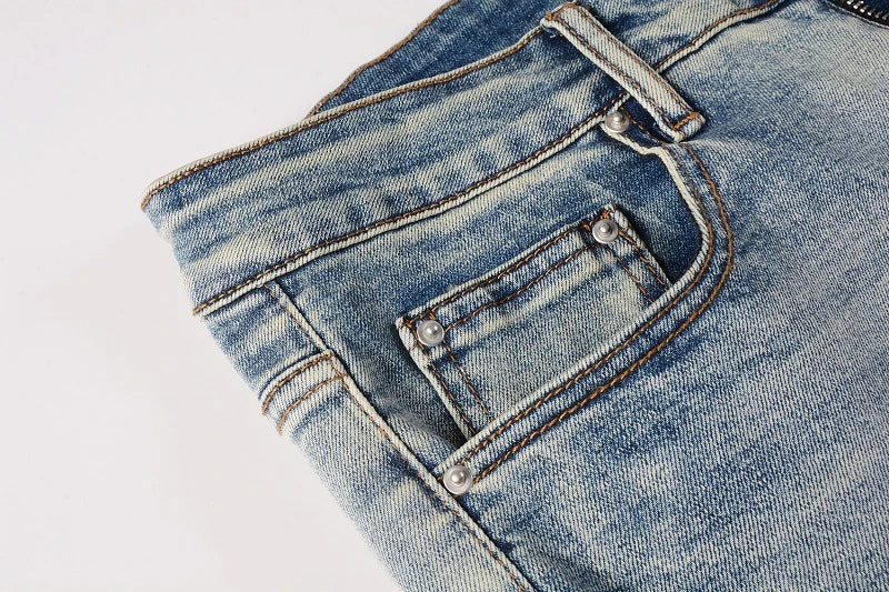 American High Street fashionable men's ripped black and white patch jeans in a light blue denim color