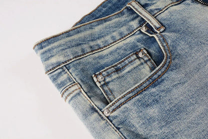 American High Street fashionable men's ripped black and white patch jeans in a light blue denim color