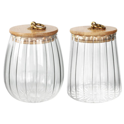 Elegant glass canisters with flower-shaped metal handles and airtight bamboo lids for stylish kitchen storage