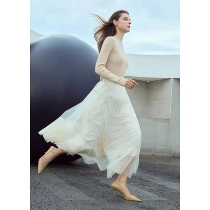 Elegant gauze A-line skirt in beige and white colors, featuring a graceful ankle-length design and unique patchwork detailing for a sophisticated look.