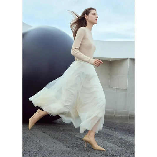 Elegant gauze A-line skirt in beige and white colors, featuring a graceful ankle-length design and unique patchwork detailing for a sophisticated look.