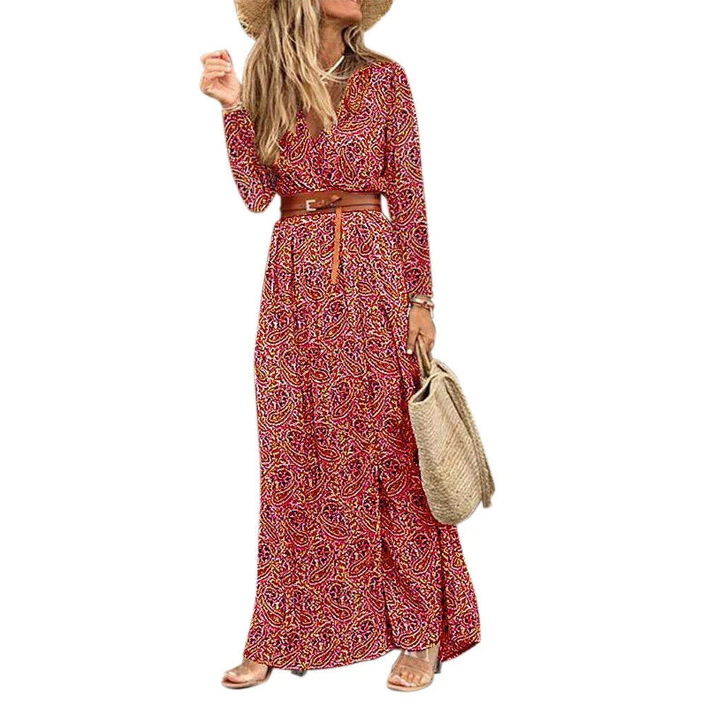 A long sleeve v-neck bohemian-style floral dress with a flowing, long skirt in a dark blue color.