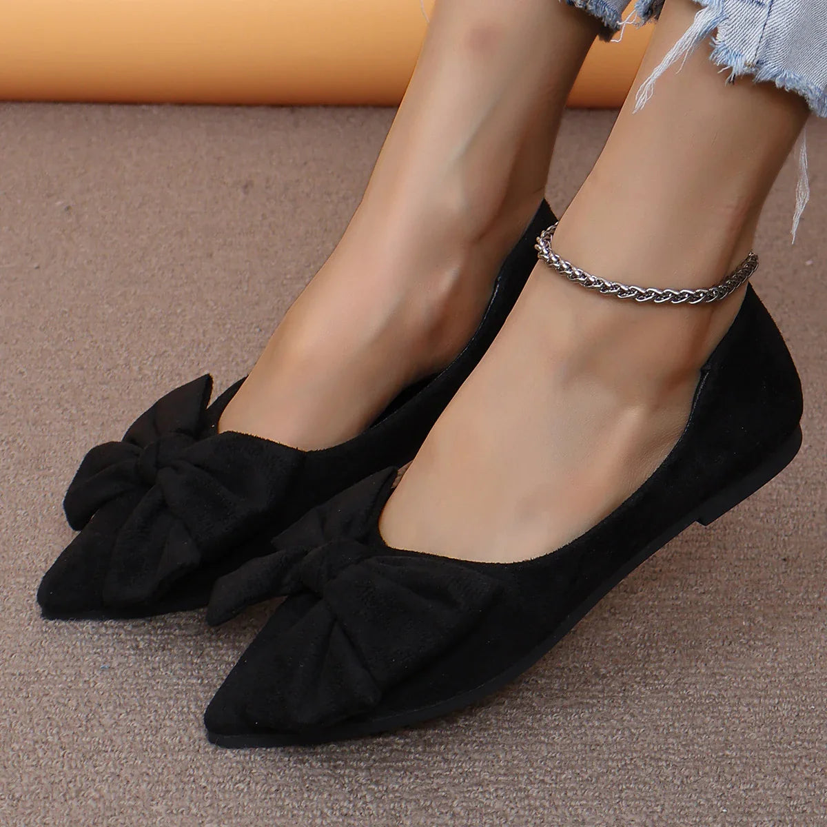 Fashionable flat shoes with bow accent, pointed toe, and low heel for comfortable, slip-on wear
