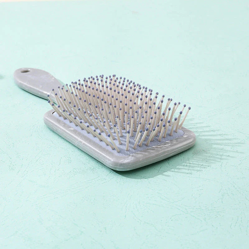 Marble Air Cushion Scalp Massage Hairbrush with air cushion technology for a soothing scalp massage and smooth, frizz-free hair