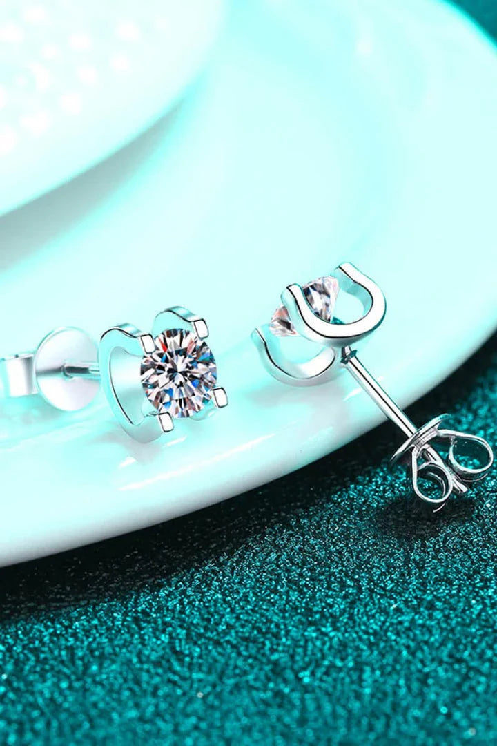 A pair of 1 carat moissanite stud earrings made of 925 sterling silver with a rhodium plating for a dazzling shine.