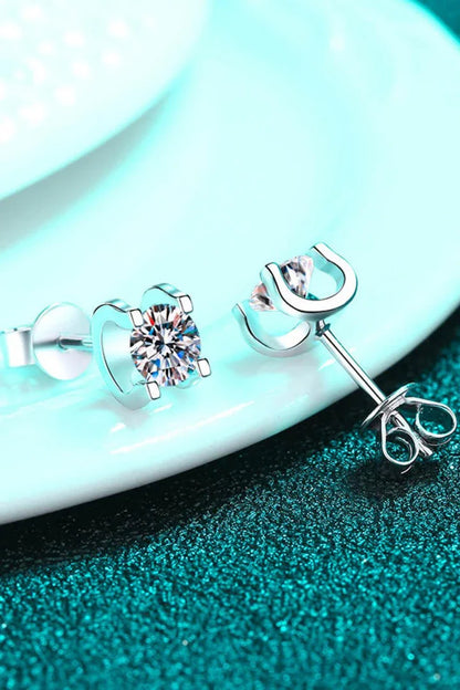A pair of 1 carat moissanite stud earrings made of 925 sterling silver with a rhodium plating for a dazzling shine.