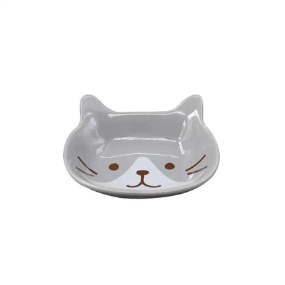 A charming Japanese-style ceramic dish featuring a cute cat design, perfect for serving sauces, dips, and small portions in style.
