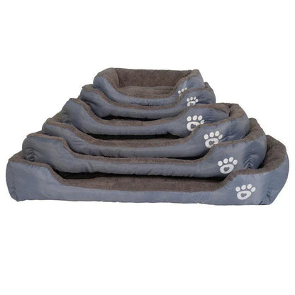 A plush, green pet bed with a paw-print pattern, designed to provide cozy and waterproof comfort for pets.