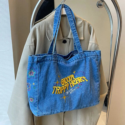 A stylish denim shoulder bag with embroidered details, perfect for everyday use and carrying all your essentials