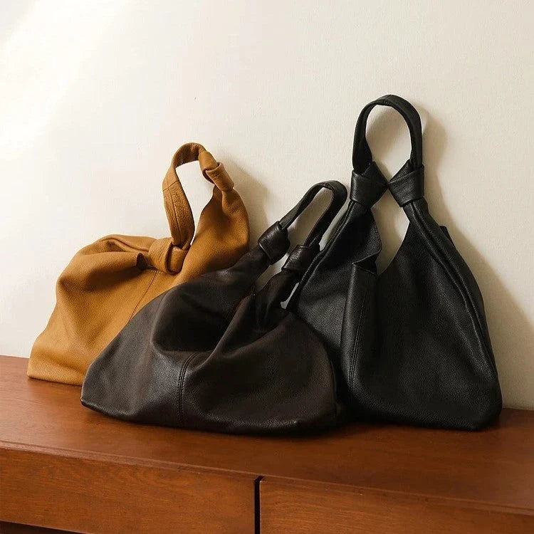 Luxurious oversized genuine leather hobo shoulder bag in black, featuring a spacious interior, multiple compartments, and a soft, flexible design for everyday use.