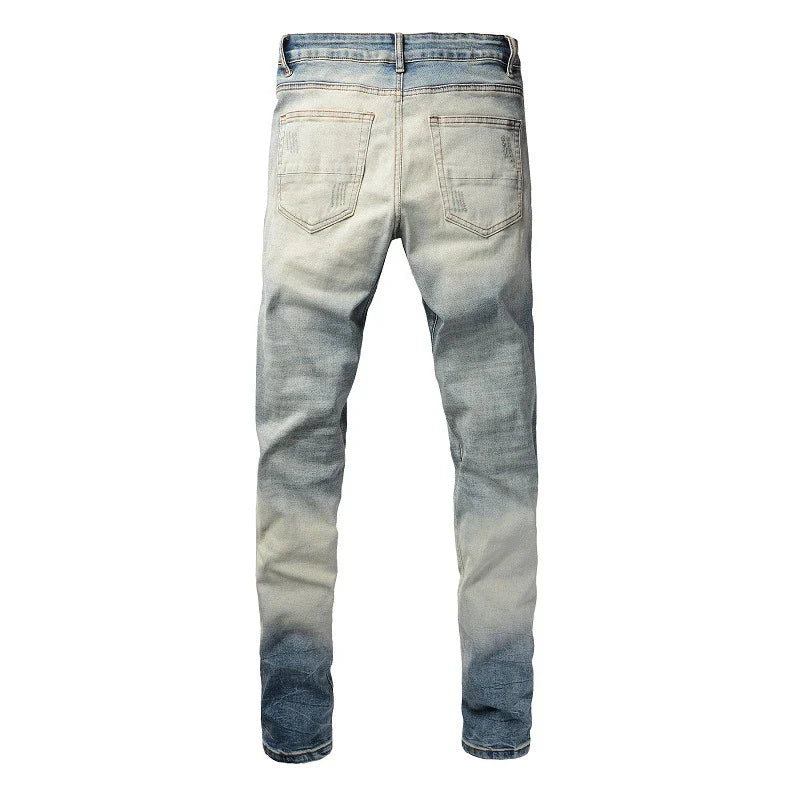 American High Street fashionable men's ripped black and white patch jeans in a light blue denim color