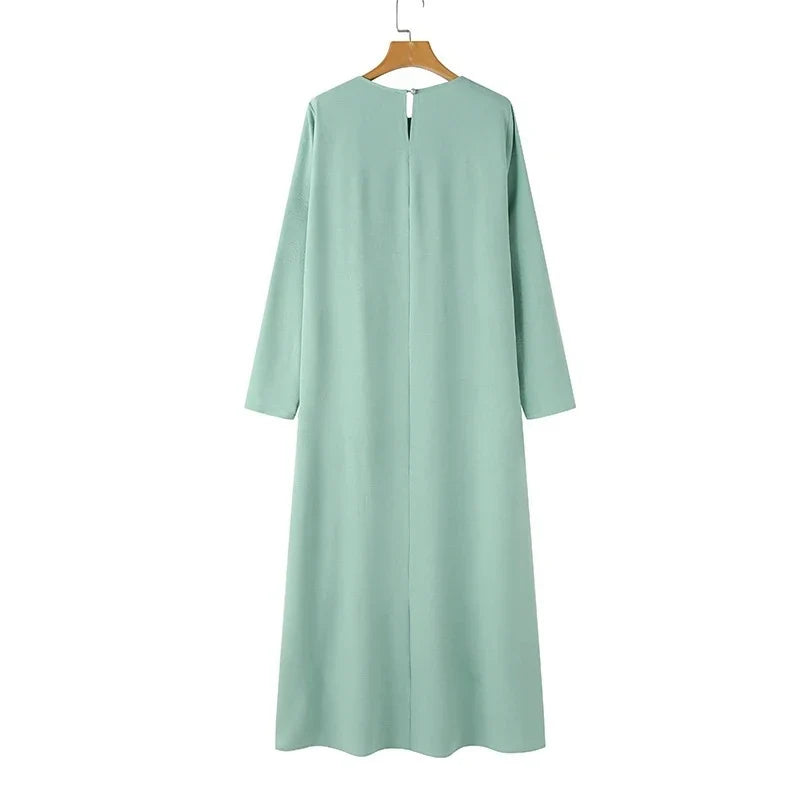 Elegant polyester dress with long sleeves, high slit hem, and available in caramel, black, blue, green, and pink colors
