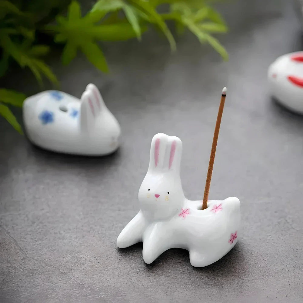 Charming ceramic incense holder featuring a cute rabbit and kitten design, perfect for adding a touch of whimsy and tranquility to any room.