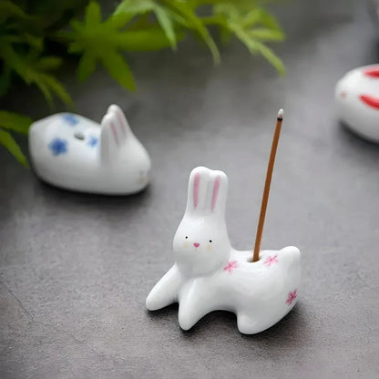 Charming ceramic incense holder featuring a cute rabbit and kitten design, perfect for adding a touch of whimsy and tranquility to any room.