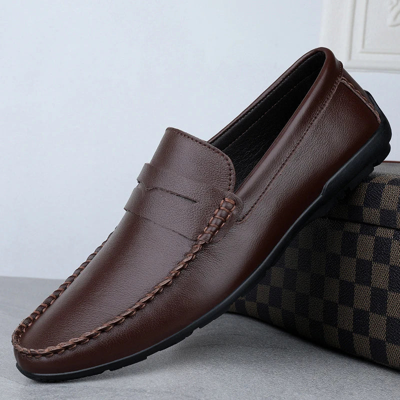 Men's driving shoes in black cowhide leather with sleek, round-toe design for superior driving control and style