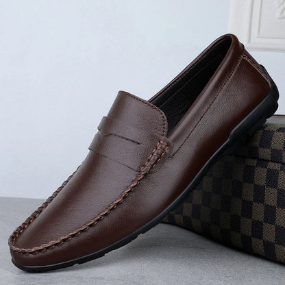 Men's driving shoes in black cowhide leather with sleek, round-toe design for superior driving control and style