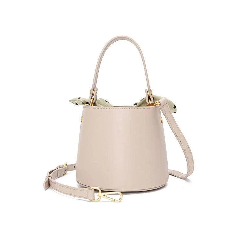 Premium leather bucket bag tote with bow-type closure, exquisite golden hardware, and versatile design