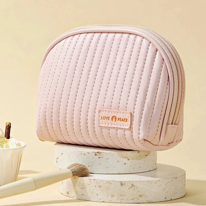 Stylish compact makeup bag made of premium PU leather in light blue color, with a sleek minimalist design for modern women