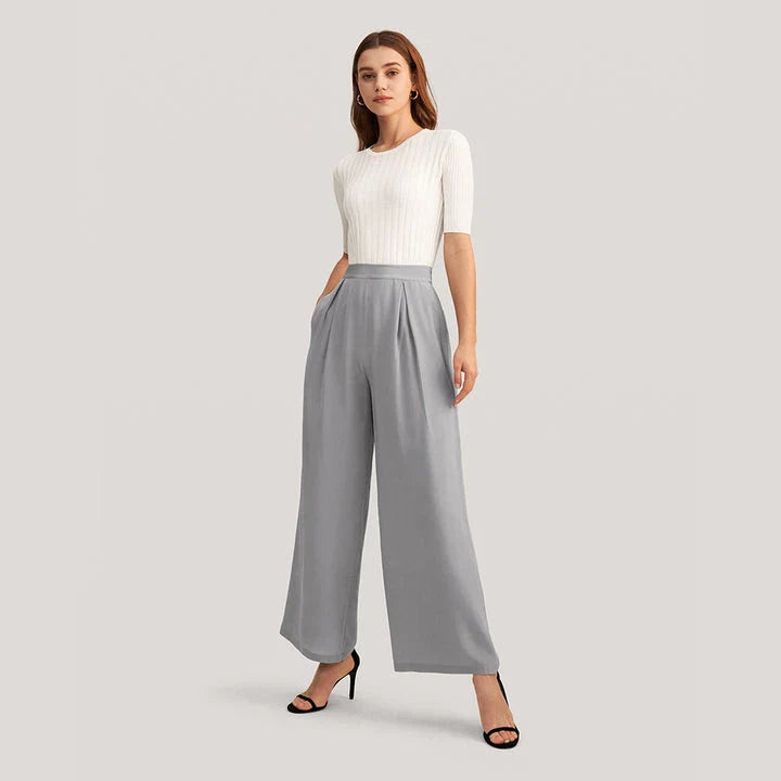 Elegant grey silk wide-leg pants with a high-waist design and concealed side zipper for a flattering, comfortable fit.