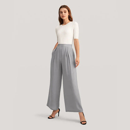 Elegant grey silk wide-leg pants with a high-waist design and concealed side zipper for a flattering, comfortable fit.