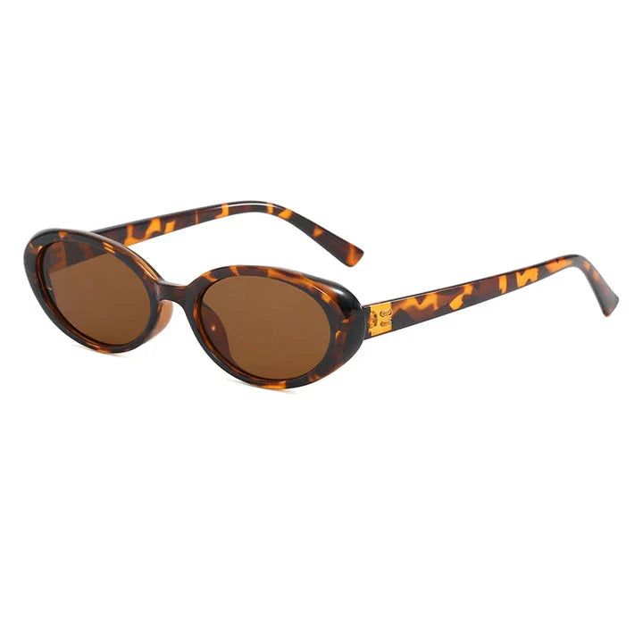 Chic oval sunglasses with white grey acetate frames and polycarbonate lenses, designed for fashionable women to shield their eyes from UV rays in style.
