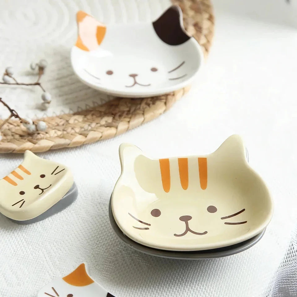 A charming Japanese-style ceramic dish featuring a cute cat design, perfect for serving sauces, dips, and small portions in style.