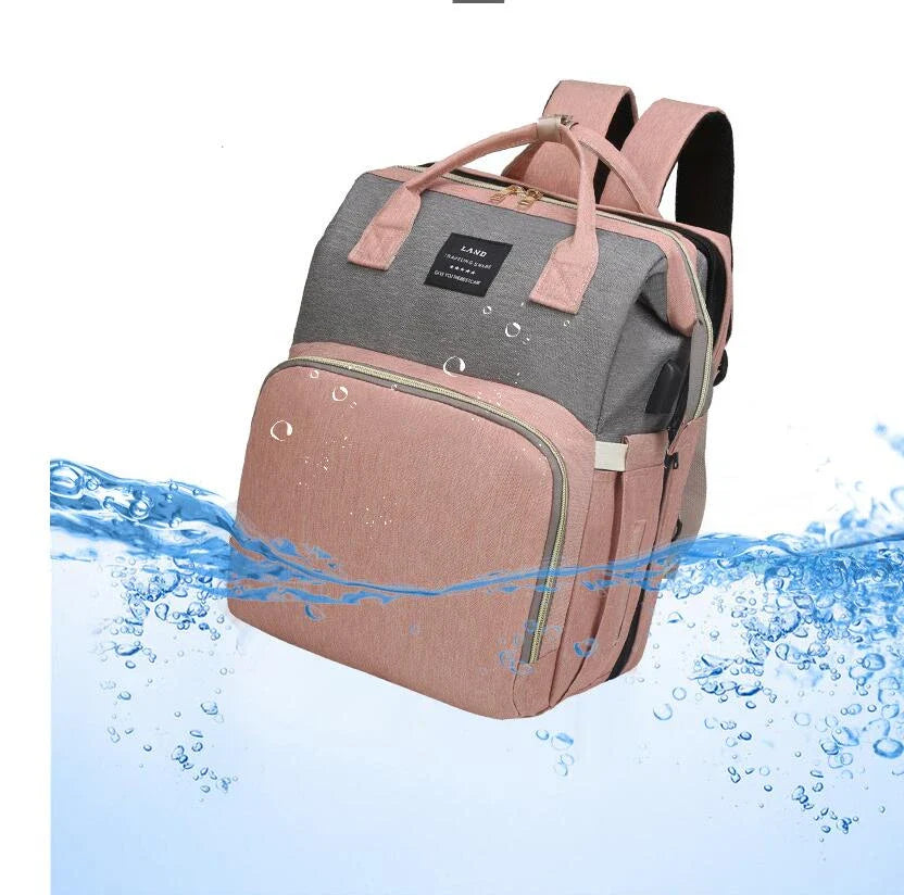 Multifunctional maternity diaper backpack with detachable crib, large capacity, and water-resistant design for travel