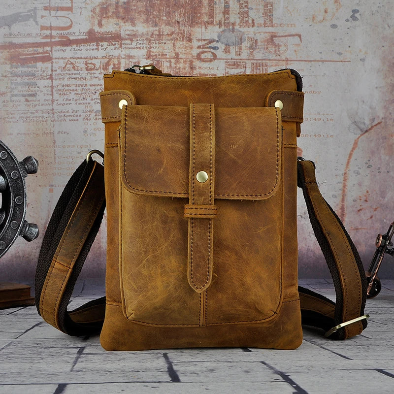 A premium cowhide leather shoulder bag with a compact and versatile design, suitable for various occasions and outdoor activities.