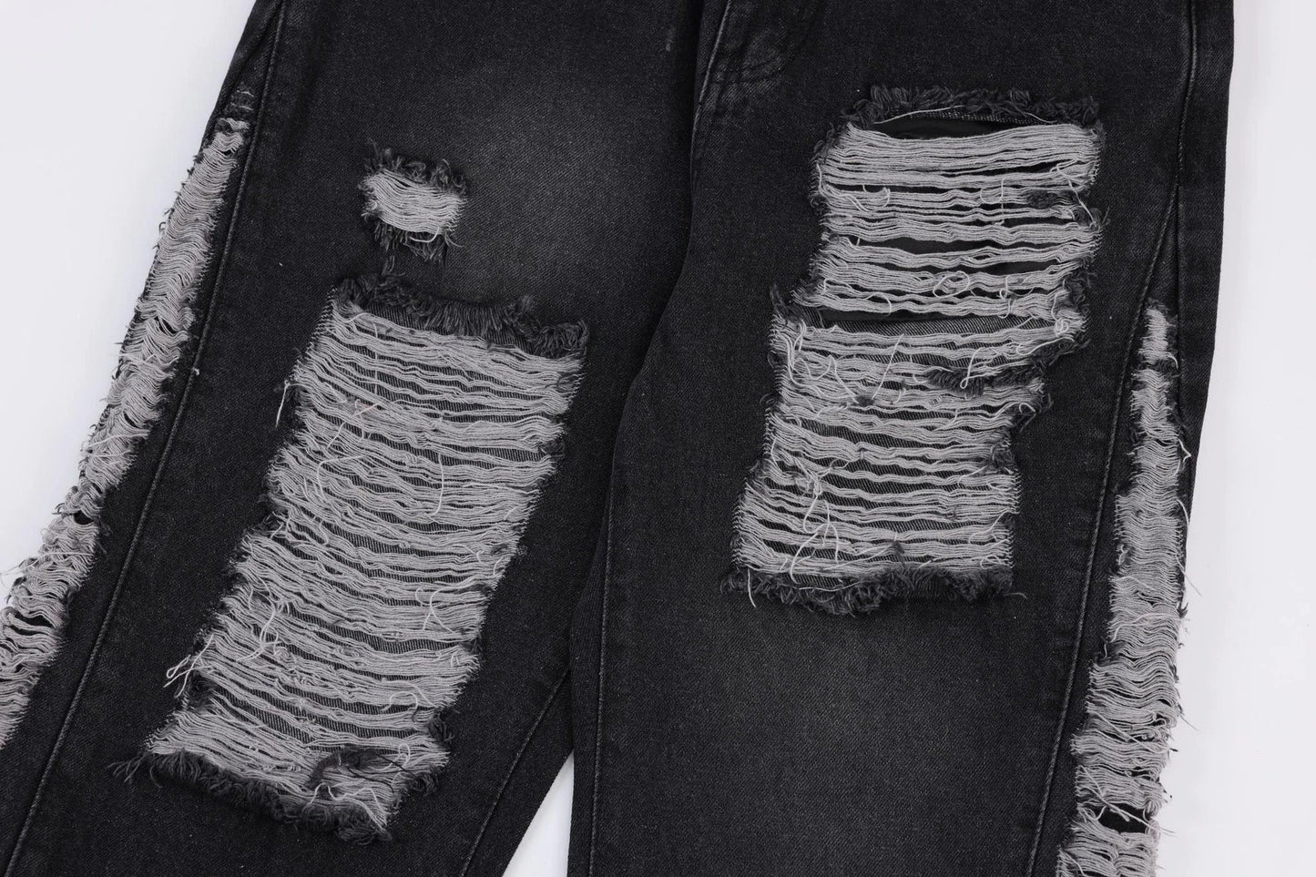 Premium loose fit distressed denim trousers for men and women, featuring a relaxed silhouette, high-quality cotton construction, and trendy distressed details.