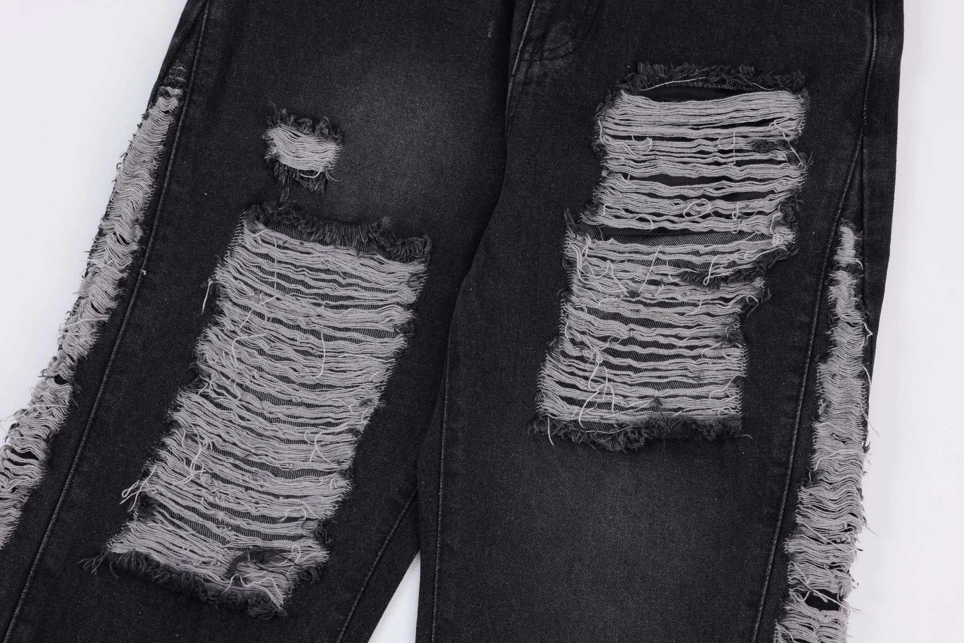 Premium loose fit distressed denim trousers for men and women, featuring a relaxed silhouette, high-quality cotton construction, and trendy distressed details.