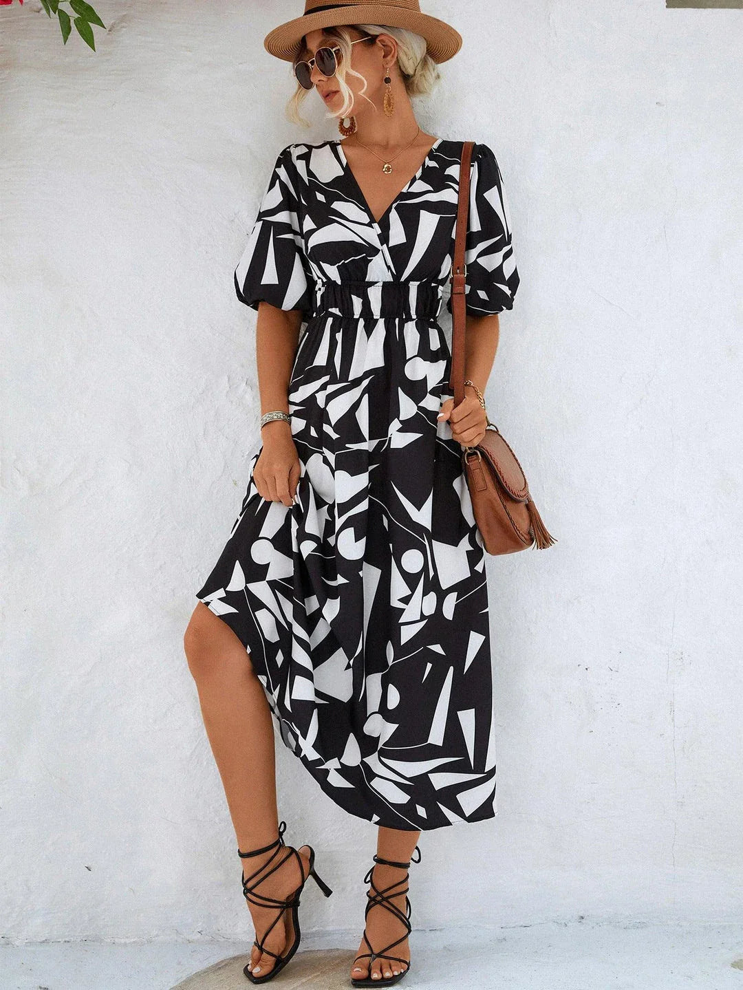 A stylish printed surplice dress with balloon sleeves, perfect for effortless elegance
