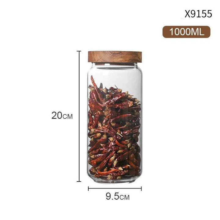 Airtight glass food storage jars with wooden lids in various sizes, perfect for organizing and preserving dry goods, spices, and pantry items in the kitchen.