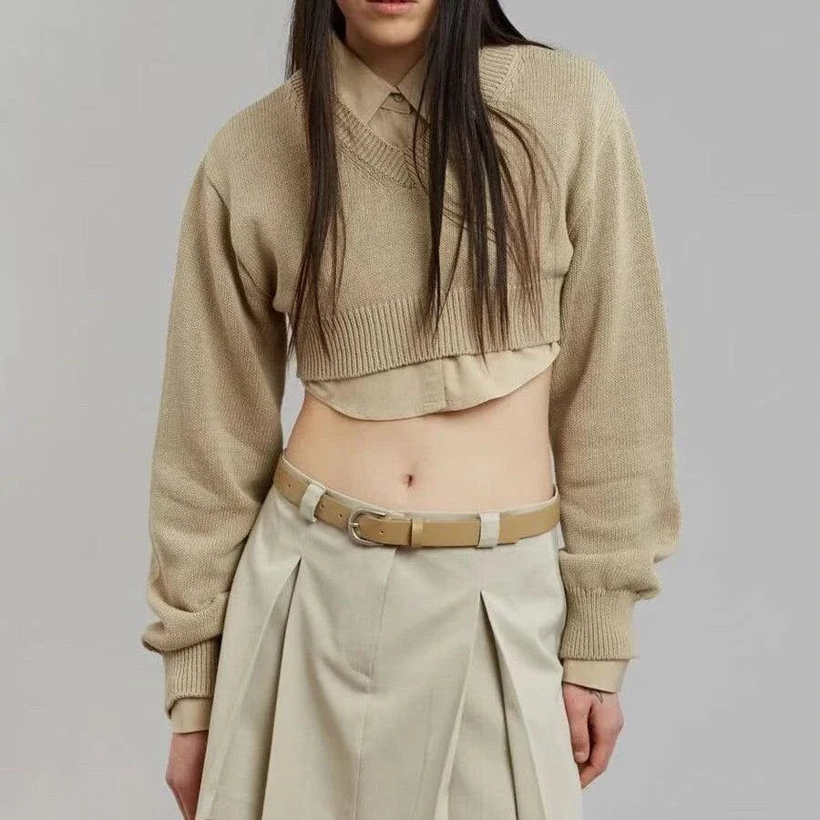 A cozy, knitted pullover sweater with a timeless round neck design, available in a versatile camel color.