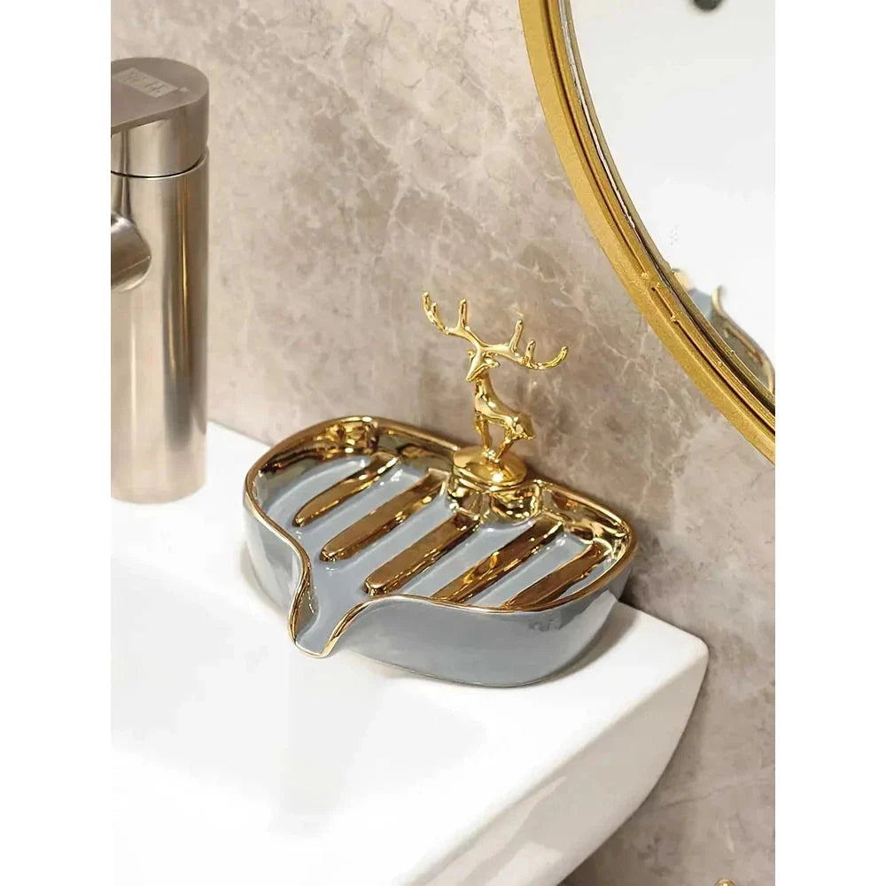 A white gold ceramic soap dish with a drainage design, showcasing a sleek and elegant bathroom accessory.