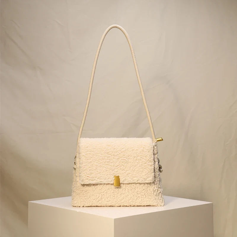 Stylish faux lamb wool crossbody shoulder bag in neutral colors with a cozy, plush exterior and organized interior pockets