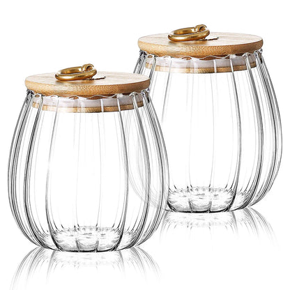 Elegant glass canisters with flower-shaped metal handles and airtight bamboo lids for stylish kitchen storage